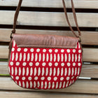 flap crossbody handbag in line & dot pattern